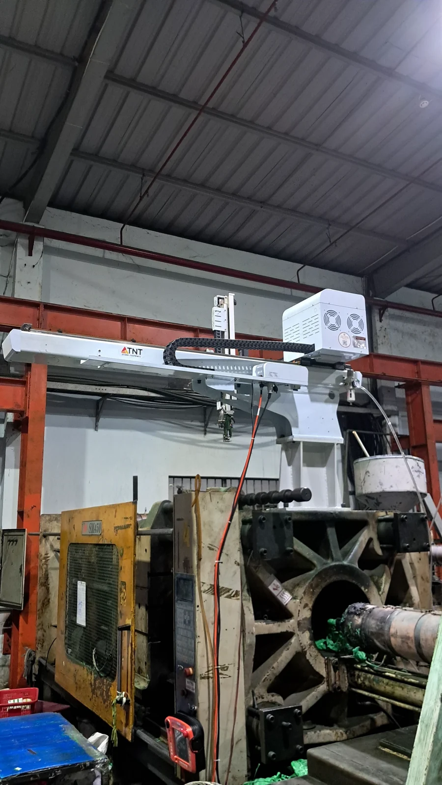 Robot TNT lắp trên máy ép nhựa đời cũ đang chạy tại xưởng